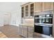 Kitchen with stainless steel Whirlpool oven, marble countertop, and glass front cabinets at 6850 Belancino Blvd., Myrtle Beach, SC 29579