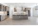 Spacious kitchen featuring custom cabinets, a large island, and stylish pendant lighting at 6850 Belancino Blvd., Myrtle Beach, SC 29579