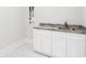 Bright laundry room with white cabinets, and grey countertop at 6850 Belancino Blvd., Myrtle Beach, SC 29579