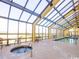 Bright indoor pool and hot tub area with plenty of seating and expansive windows at 6900 N Ocean Blvd. # 834, Myrtle Beach, SC 29577