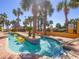 Community lazy river pool with tropical plants and zero entry at 6900 N Ocean Blvd. # 834, Myrtle Beach, SC 29577
