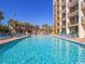 Large outdoor pool with palm trees and lounge chairs at 6900 N Ocean Blvd. # 834, Myrtle Beach, SC 29577