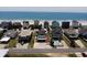 Aerial view showcasing a beachfront community with beautiful ocean views and private pools at 710 S Waccamaw Dr., Garden City Beach, SC 29576