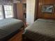 Bright bedroom showcasing two beds, storage, and an adjacent bathroom with a hardwood floor at 710 S Waccamaw Dr., Garden City Beach, SC 29576