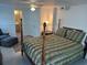 Comfortable bedroom with a queen-sized bed and ensuite bathroom at 710 S Waccamaw Dr., Garden City Beach, SC 29576