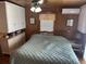 This cozy bedroom features wood paneling, built-in storage, and a comfortable queen-sized bed at 710 S Waccamaw Dr., Garden City Beach, SC 29576