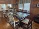 Dining area with a glass-top table, mix-and-match chairs, and paneled walls at 710 S Waccamaw Dr., Garden City Beach, SC 29576