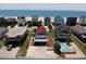 Aerial view of beach home with covered parking, deck, and ocean views at 710 S Waccamaw Dr., Garden City Beach, SC 29576
