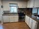 Kitchen with stainless steel appliances and stone countertops at 710 S Waccamaw Dr., Garden City Beach, SC 29576