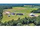 Stunning aerial view of the entire property, showcasing the home, barn, paddocks, and surrounding acreage at 7356 Johnson Shortcut Rd., Conway, SC 29527