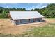 Large barn with a metal roof and wooden accents, perfect for equestrian activities or storage at 7356 Johnson Shortcut Rd., Conway, SC 29527