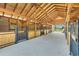 Spacious barn interior with wooden accents, multiple stalls and an open doorway overlooking a pasture at 7356 Johnson Shortcut Rd., Conway, SC 29527