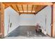 Empty interior of a horse barn with rubber mat flooring, white walls, and wood beam supports at 7356 Johnson Shortcut Rd., Conway, SC 29527