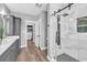 Bathroom showcasing a walk-in shower with marble tile and a modern vanity with ample storage at 7356 Johnson Shortcut Rd., Conway, SC 29527