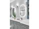 Modern bathroom with double sinks, vanity mirrors, and sleek faucets on a white countertop at 7356 Johnson Shortcut Rd., Conway, SC 29527