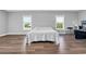 Large bedroom features hardwood floors and plenty of natural light from the multiple windows at 7356 Johnson Shortcut Rd., Conway, SC 29527
