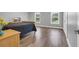 Spacious bedroom with beautiful light hardwood floors, two windows and stylish furniture at 7356 Johnson Shortcut Rd., Conway, SC 29527