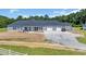 Beautifully landscaped home with a large driveway, three-car garage, and charming front porch at 7356 Johnson Shortcut Rd., Conway, SC 29527