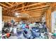 Unfinished garage with exposed rafters and an array of tools, storage bins, and equipment at 7356 Johnson Shortcut Rd., Conway, SC 29527