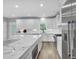 Bright kitchen boasting white cabinetry, stainless steel appliances, marble countertops, and a center island for cooking at 7356 Johnson Shortcut Rd., Conway, SC 29527