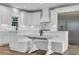 Close up of a well-appointed kitchen featuring white cabinets, marble countertops, and stainless steel appliances at 7356 Johnson Shortcut Rd., Conway, SC 29527