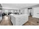 Large kitchen island with white cabinets, marble countertops, and seating, ideal for meal prep and entertaining at 7356 Johnson Shortcut Rd., Conway, SC 29527