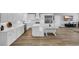 Spacious kitchen with white cabinets, a center island, stainless steel appliances, and wood-look flooring for a modern look at 7356 Johnson Shortcut Rd., Conway, SC 29527