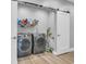 Convenient laundry room featuring modern washer and dryer with sliding door and shelving at 7356 Johnson Shortcut Rd., Conway, SC 29527