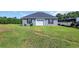 Exterior view of a blue, single-story outbuilding or garage with white doors and black shutters at 7356 Johnson Shortcut Rd., Conway, SC 29527