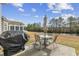 Backyard patio with outdoor dining set, grill, and serene waterfront views at 755 Wintercreeper Dr., Longs, SC 29568