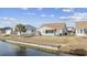 The backyard features a waterfront view, a playset, and an outdoor grill at 755 Wintercreeper Dr., Longs, SC 29568