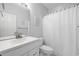 Clean bathroom featuring white sink vanity, large mirror, and shower with a white curtain at 755 Wintercreeper Dr., Longs, SC 29568