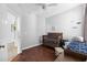 Bedroom with hardwood floors, ceiling fan, wooden crib, and sitting chair at 755 Wintercreeper Dr., Longs, SC 29568