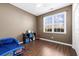Bright bedroom with brown walls, laminated wood floor, a large window, and an adorable race car bed at 755 Wintercreeper Dr., Longs, SC 29568