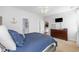 Bedroom featuring a bed with a blue comforter, wood dresser, and beige carpeting at 755 Wintercreeper Dr., Longs, SC 29568
