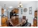 Dining nook with chandelier lighting, a wood table set, and views of the kitchen at 755 Wintercreeper Dr., Longs, SC 29568