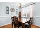 Dining nook showcasing light blue walls, chandelier lighting, and a wood table at 755 Wintercreeper Dr., Longs, SC 29568