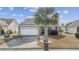 Charming single-story home with a well-manicured lawn and a white two-car garage at 755 Wintercreeper Dr., Longs, SC 29568