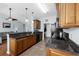 Kitchen showcasing wood cabinets, tile flooring, black appliances, and granite countertops at 755 Wintercreeper Dr., Longs, SC 29568