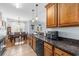 Kitchen featuring wood cabinets, granite countertops, tile flooring, and a breakfast nook at 755 Wintercreeper Dr., Longs, SC 29568