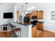 Kitchen featuring wood cabinetry, granite countertops, and a breakfast bar with seating for two at 755 Wintercreeper Dr., Longs, SC 29568