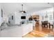 Open-concept living room with hardwood floors flowing into a kitchen and breakfast nook area at 755 Wintercreeper Dr., Longs, SC 29568