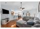 Open-concept living room with a ceiling fan, hardwood floors, and modern furnishings at 755 Wintercreeper Dr., Longs, SC 29568