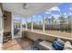 Comfortable screened porch with waterfront views, outdoor seating, and ceiling fan at 755 Wintercreeper Dr., Longs, SC 29568