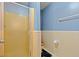Bathroom with a shower featuring a textured glass door and beige tiling at 800 9Th Ave. S # N-1, North Myrtle Beach, SC 29582
