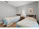 Comfortable bedroom featuring two twin beds, wood floors, and neutral gray walls at 800 9Th Ave. S # N-1, North Myrtle Beach, SC 29582