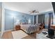 Well-furnished bedroom with blue walls, wood-look floors, a ceiling fan, and seating area at 800 9Th Ave. S # N-1, North Myrtle Beach, SC 29582