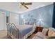 Comfortable bedroom featuring blue walls, a ceiling fan, and a cozy seating area at 800 9Th Ave. S # N-1, North Myrtle Beach, SC 29582