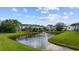 Scenic backyard view with a tranquil pond, fountain, and well-maintained lawn at 807 Wilshire Ln. # 807, Murrells Inlet, SC 29576