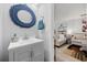 Stylish bathroom with a modern vanity and a charming, decorative round mirror at 807 Wilshire Ln. # 807, Murrells Inlet, SC 29576